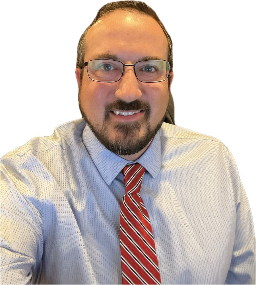 Eric Ryckman in a shirt and tie during his time at Tesla